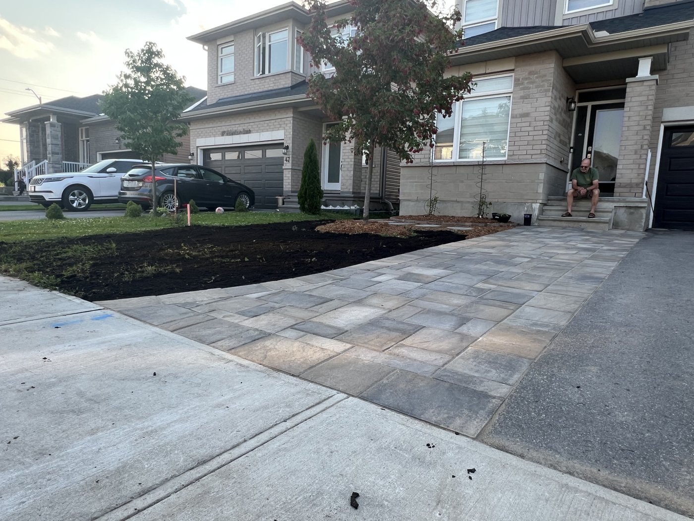 New interlock walkway and driveway extension at a front entrance