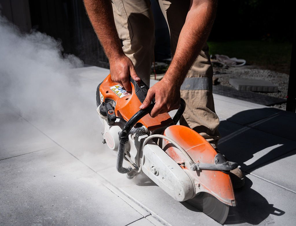 Close detail of a paver being cut for a tight edge fit