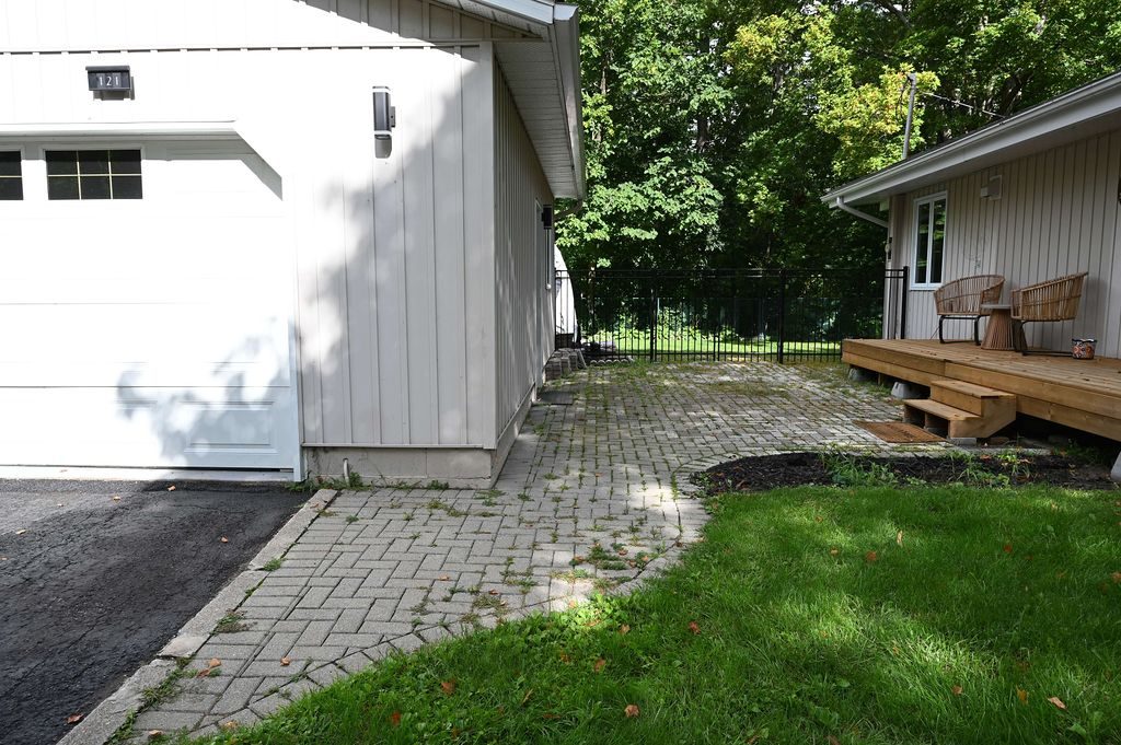 Wide view of the old patio running between the garage and the house before the rebuild