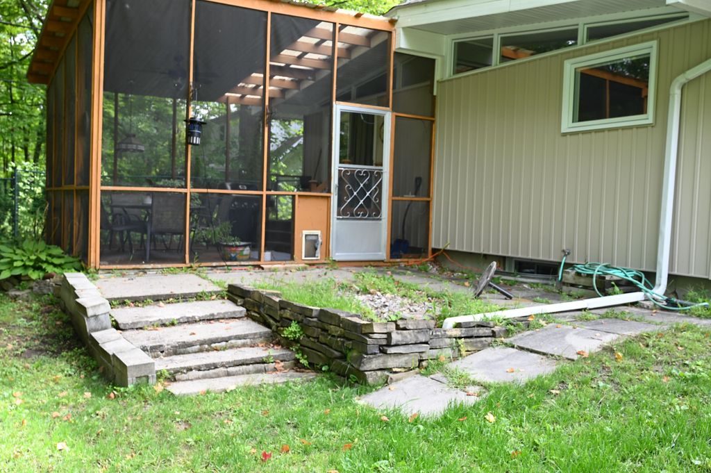 Old stone steps leading up to the screened porch before replacement
