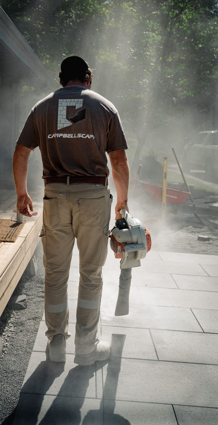 Crew member walking across the newly cut and finished patio surface