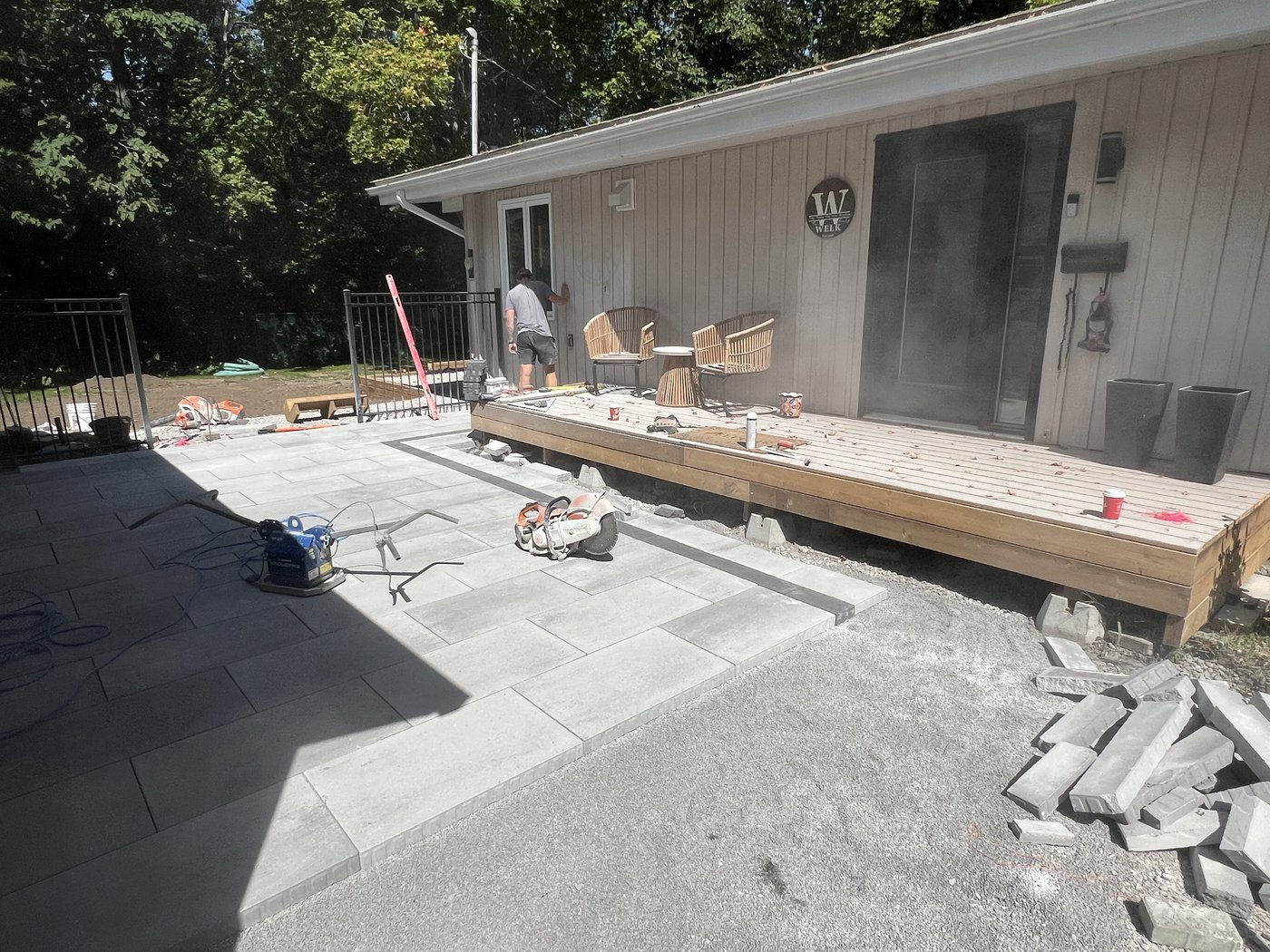 Large sections of the patio laid with the plate compactor and stone saw staged for the next course